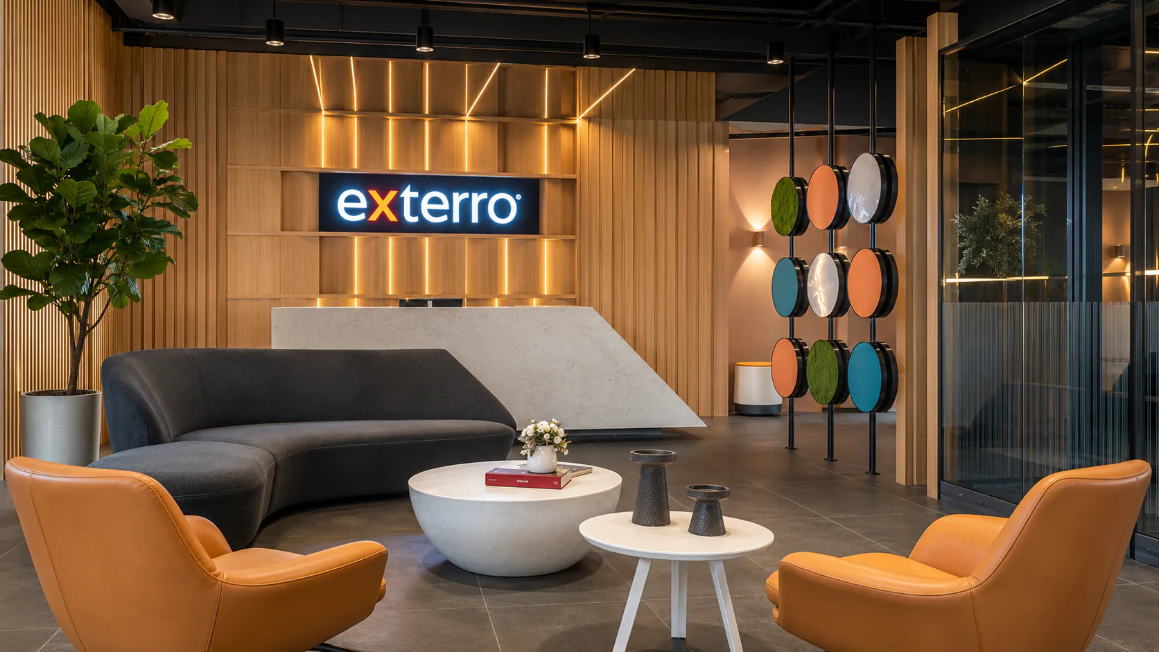 Exterro reception with illuminated signage, angular desk and lounge seating.