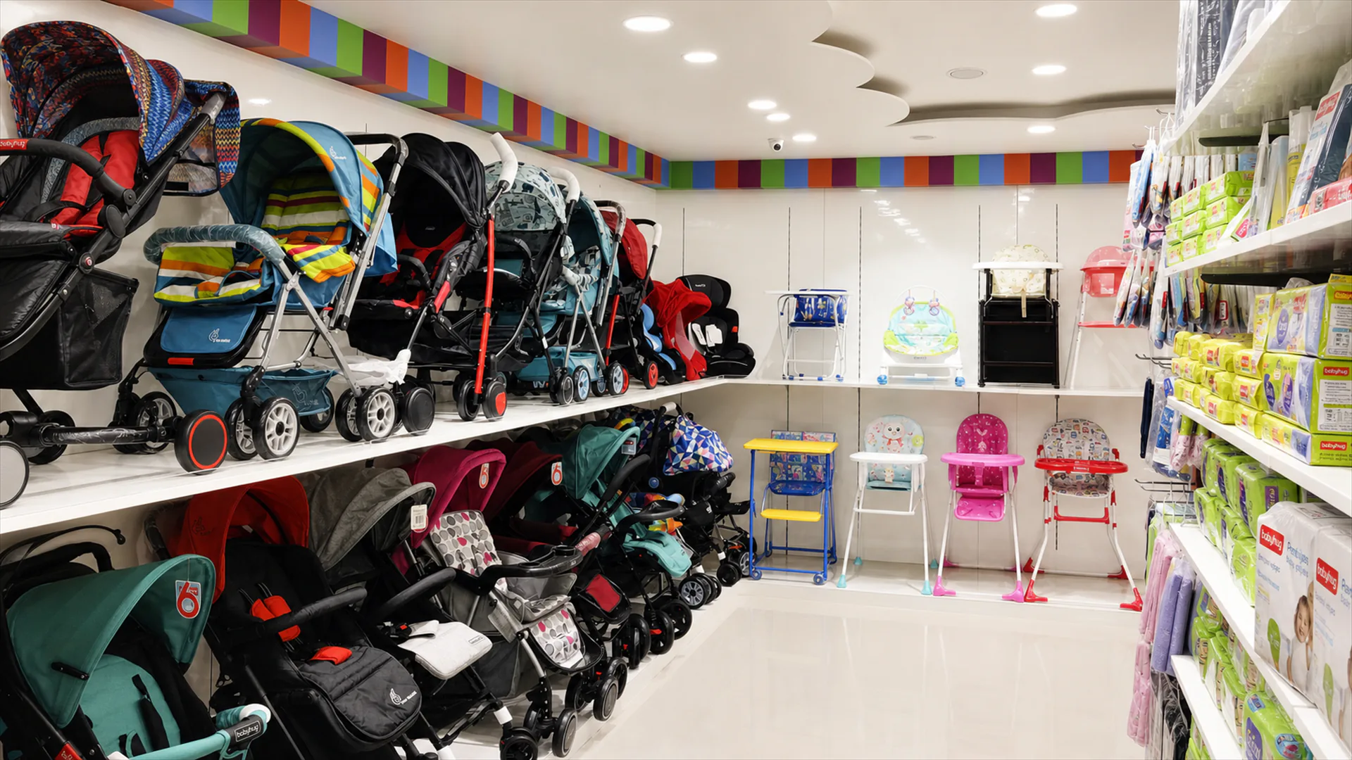 Baby equipment section displaying strollers, car seats and high chairs.