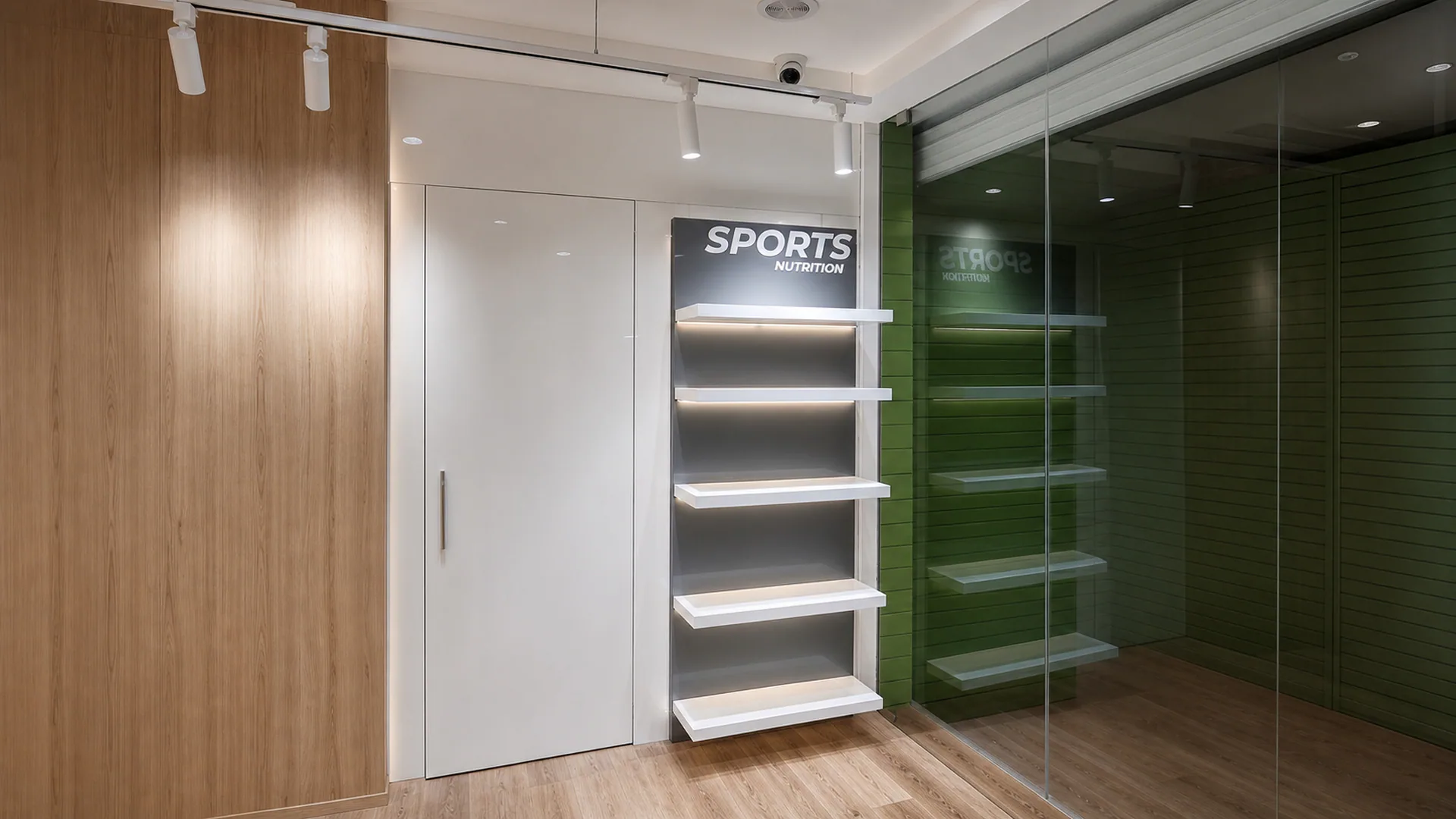 Interior display area with labeled shelving and a glazed green enclosure.