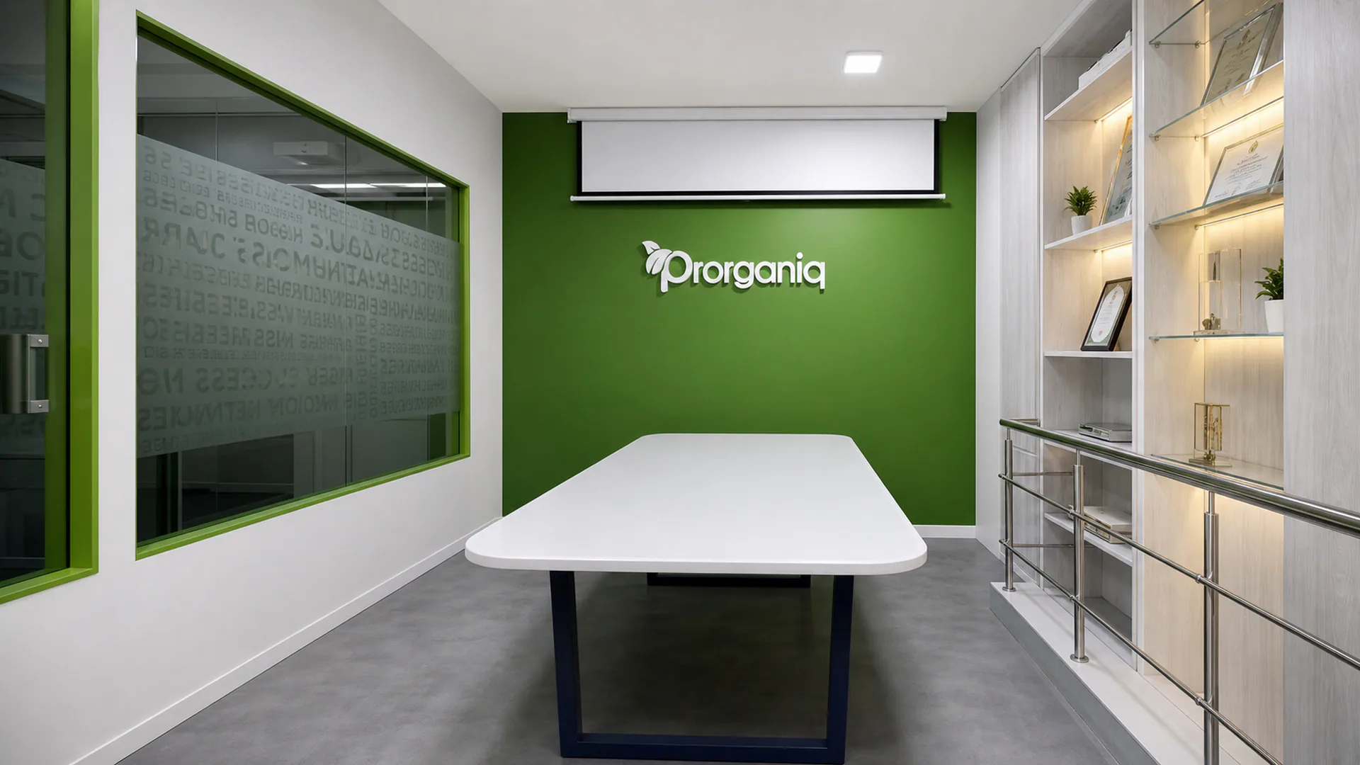 Meeting room with a central white table, green end wall and glazed partition.