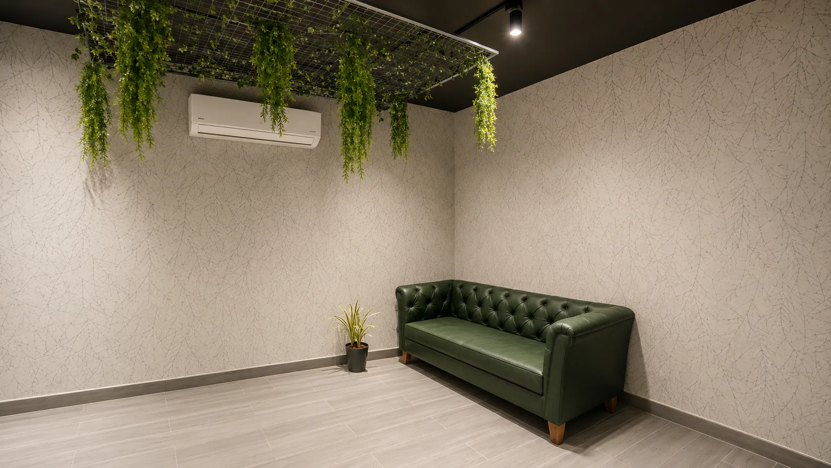 Sukriti Ayur waiting room with a green sofa beneath hanging plants.
