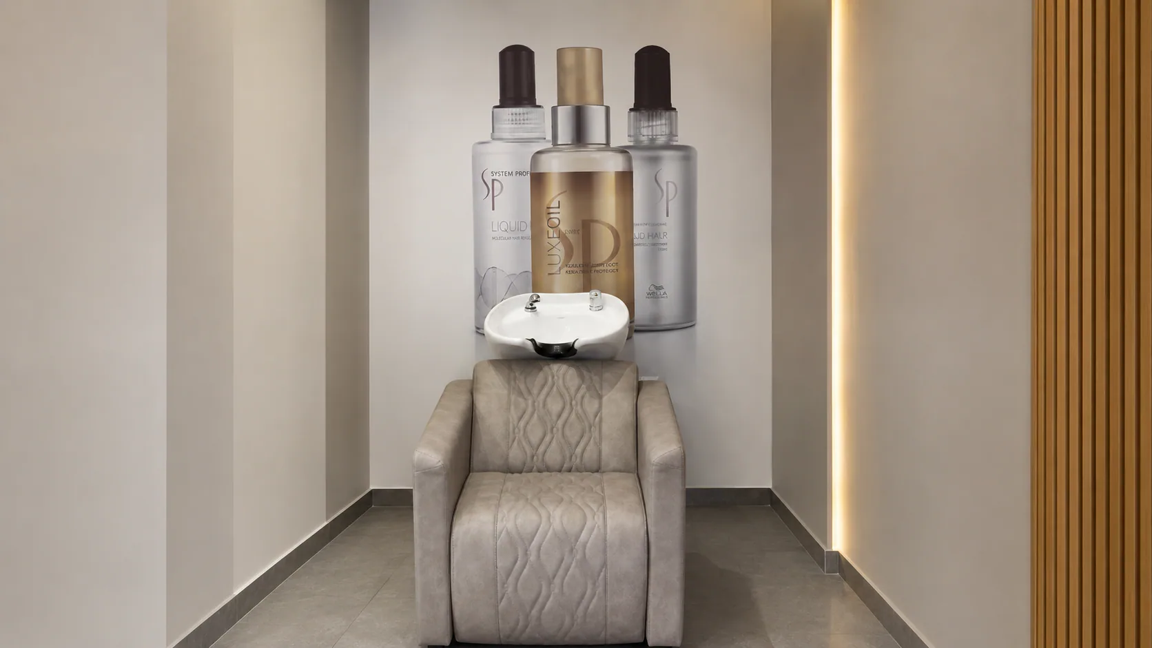 Toni & Guy wash station beneath a product display.