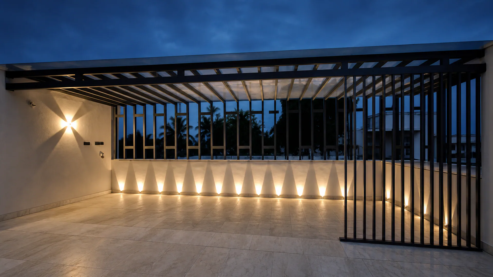 Evening terrace with vertical screens and wall lights beneath a dark sky.