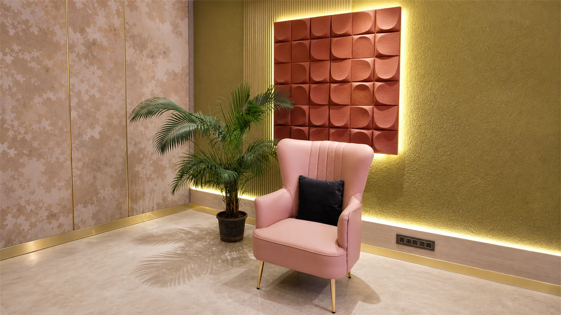 Feature chair beneath a backlit red wall panel beside a potted palm in a warmly lit residential interior.