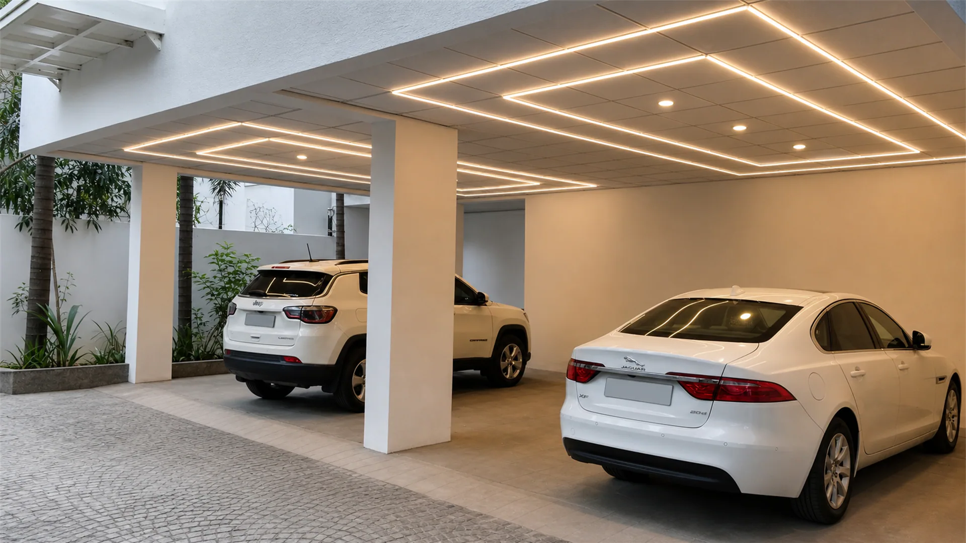 Covered residential parking area with geometric linear ceiling lighting and three parked cars.
