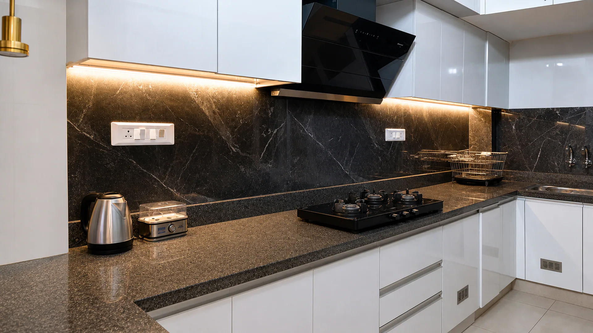 Kitchen with white cabinetry, blue upper cabinets, dark backsplash and cooktop.