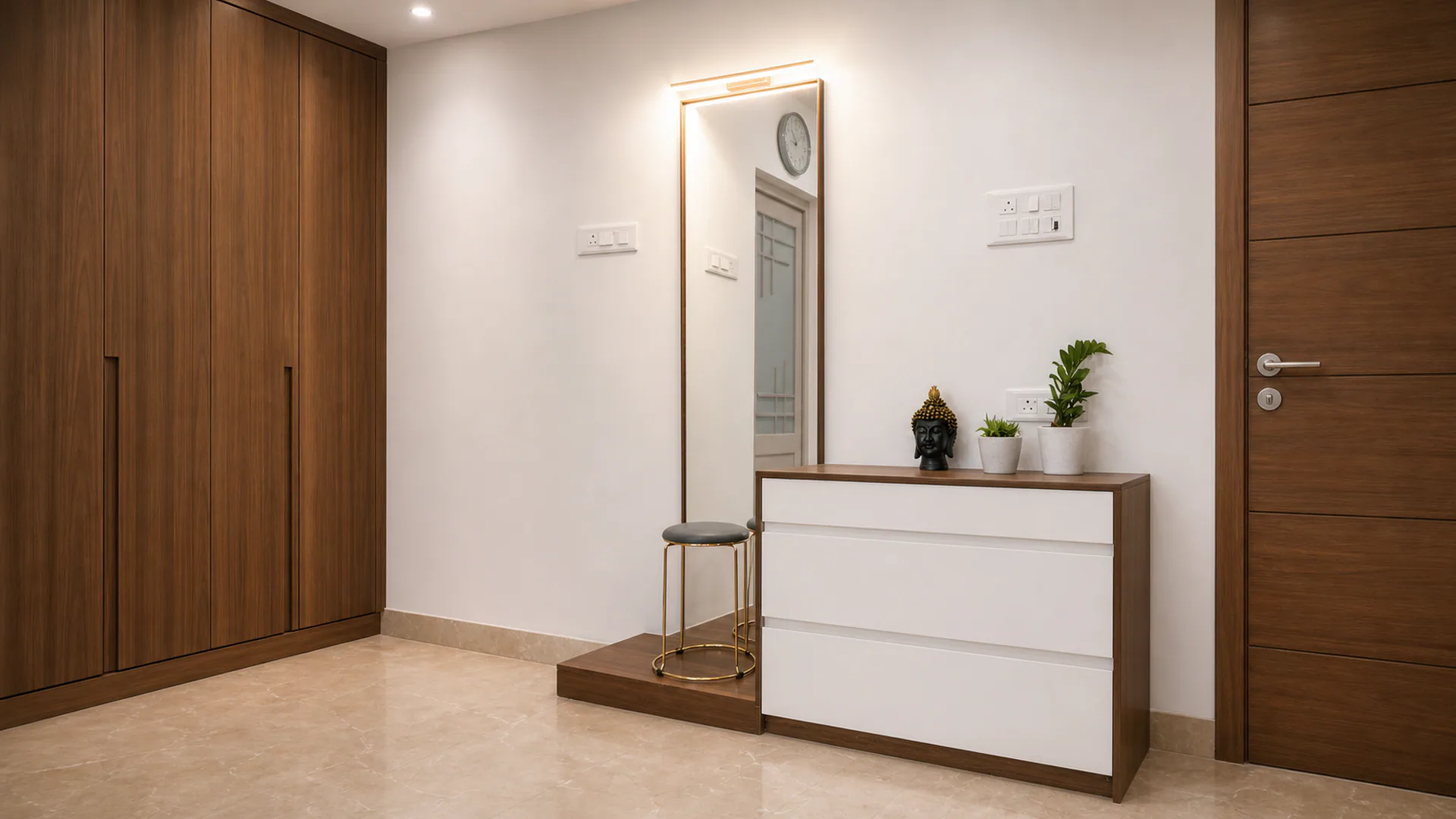 Dressing area with a full-height mirror, white drawers and tall storage.